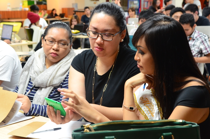Judges checking the app of one of the presenters